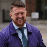 Tommy Robinson charged after attending antisemitism march in London